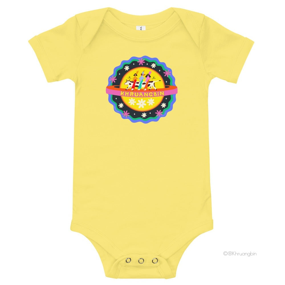 baby onesie-yellow-kbin walking in front of cow with small flowers
